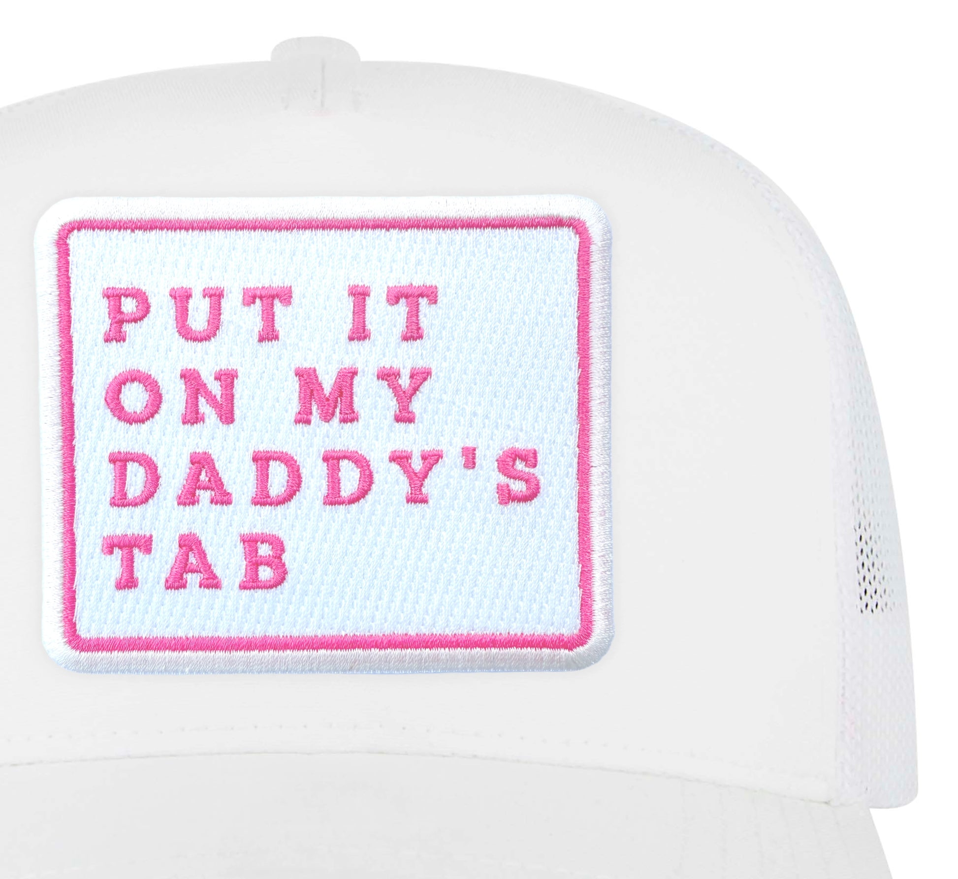 Close-up of the Put It On My Daddy's Tab embroidered patch on a white trucker hat