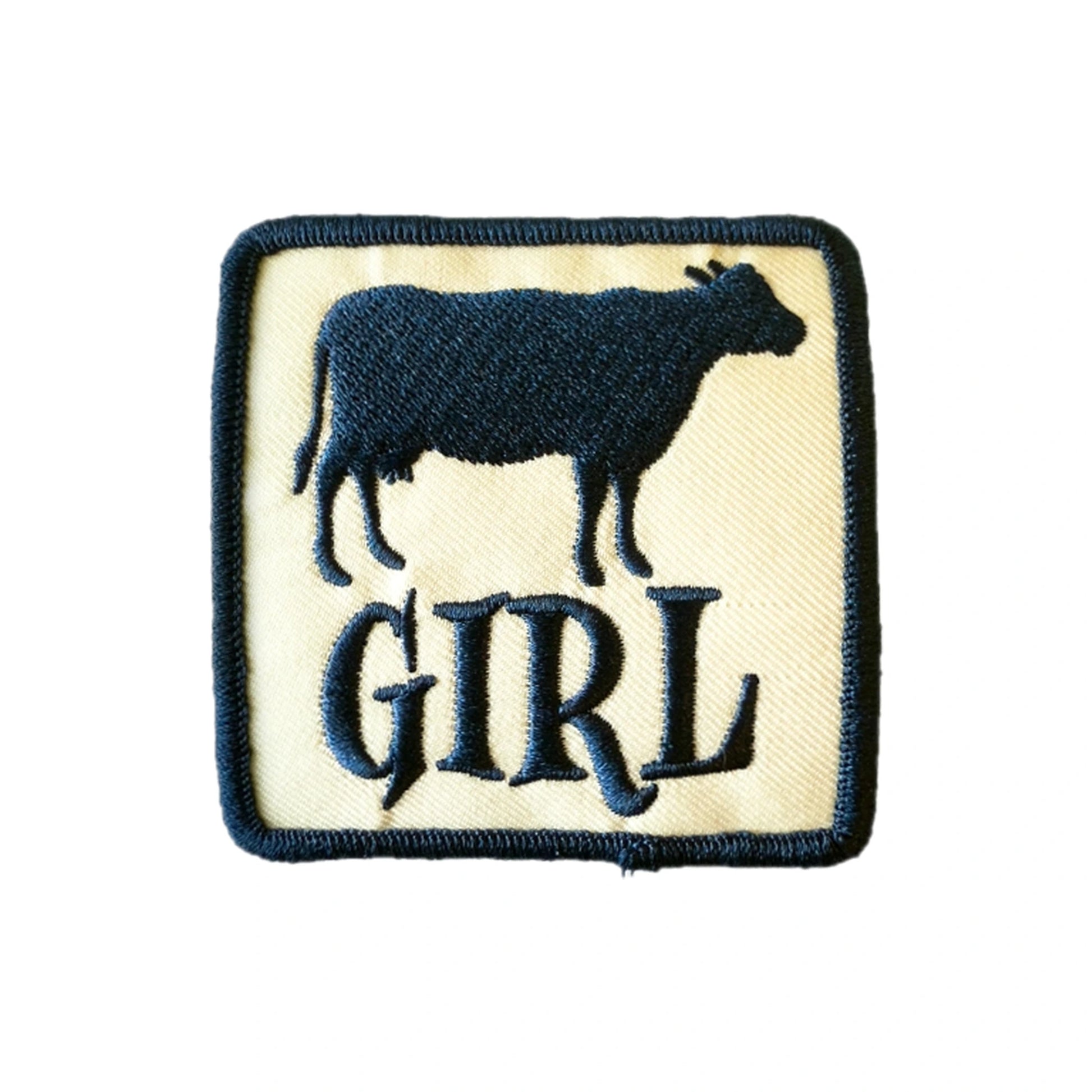 Cow Girl embroidered iron-on patch, navy cow and lettering on cream with navy border