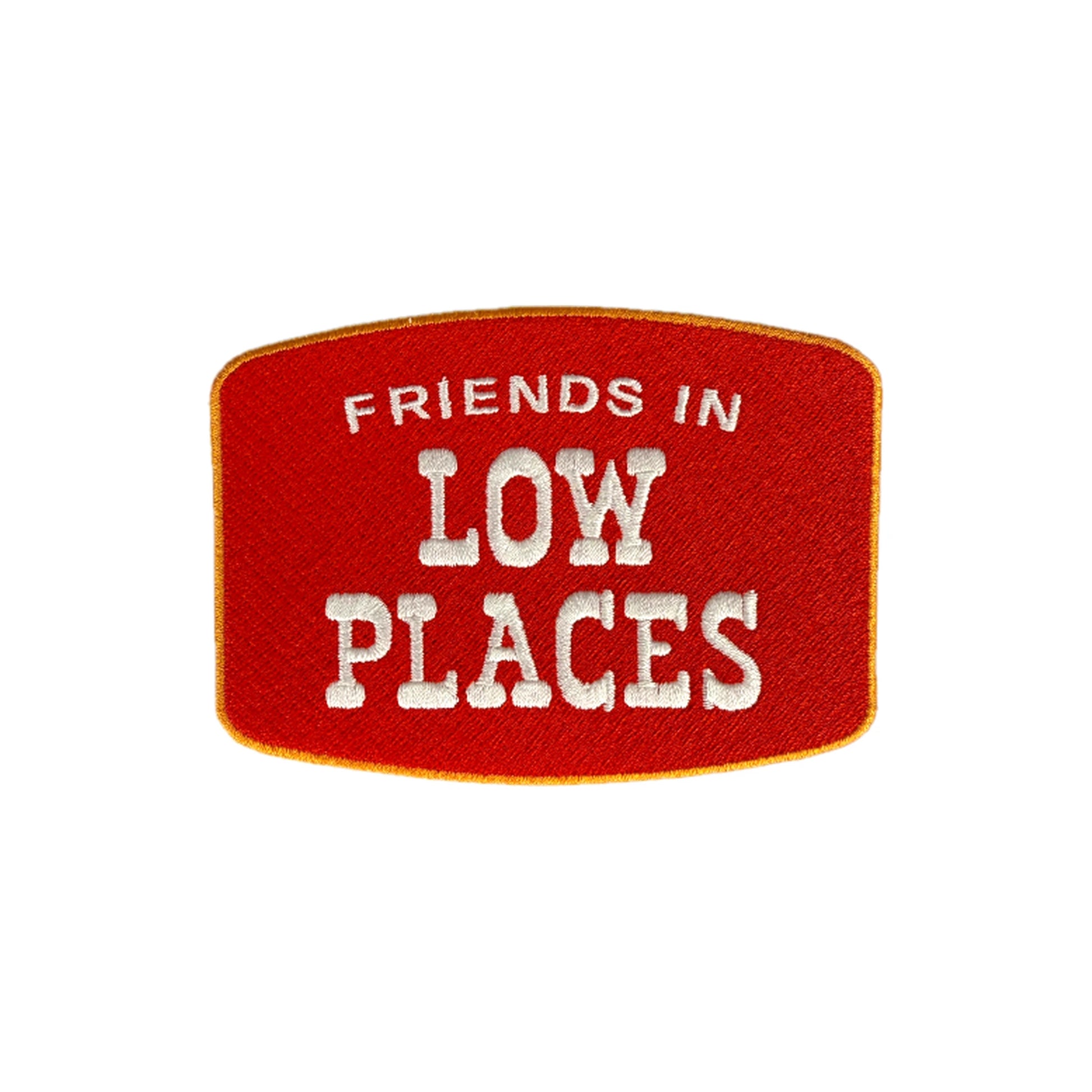 Friends In Low Places embroidered iron-on patch in red with gold border and cream lettering