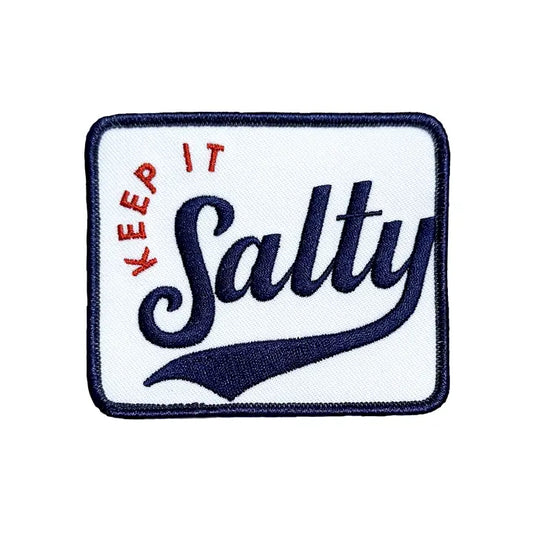 Keep It Salty embroidered iron-on patch with a navy border and vintage ballpark script lettering on a plain white background