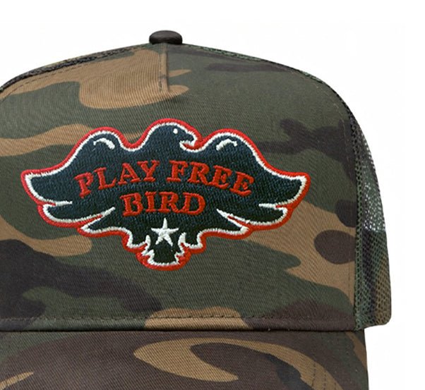 Play Free Bird trucker hat in camouflage, close-up of patch