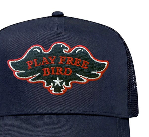 Play Free Bird trucker hat in navy, close-up of patch
