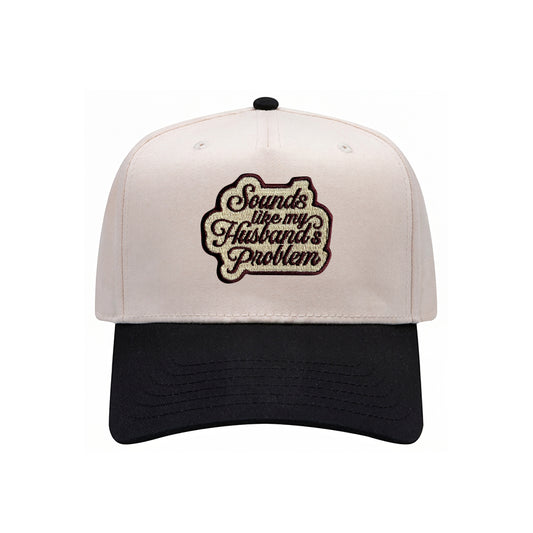 Sounds Like My Husband's Problem trucker hat in black with natural mesh, front view