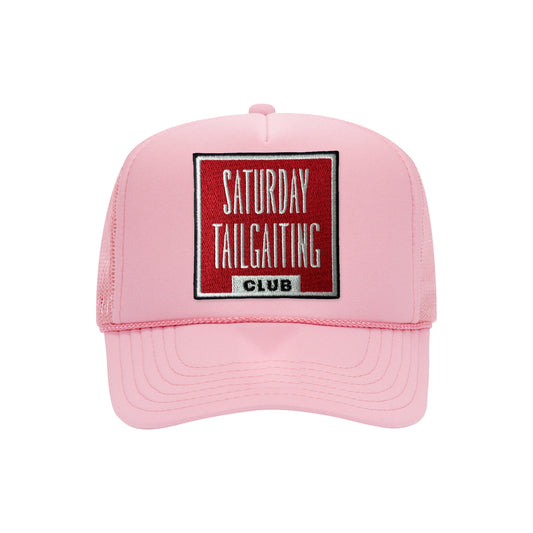 Saturday Tailgating Club embroidered patch on a soft pink high-profile foam trucker hat