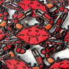 Collection of red and black crab patches on a white background